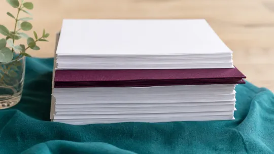 Stack of clinical reports for an NDIS specialist needs assessment
